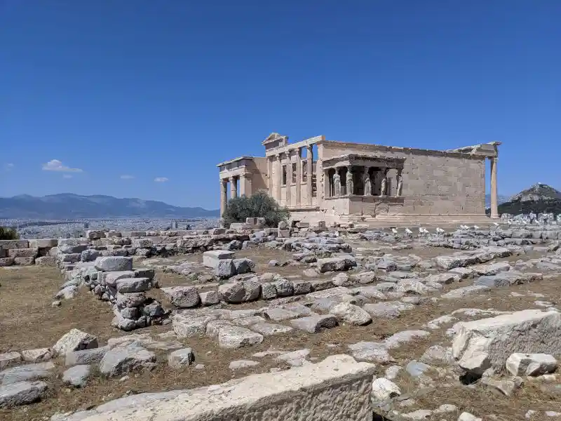 Ancient marble temple on the Acropolis with Caryatid porch and panoramic city view